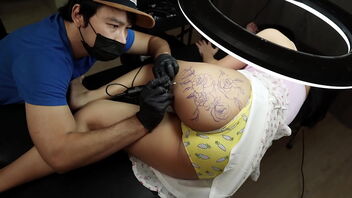 Warm vignette of a tattooed girl with a nice arse getting a rough fuck from the tattoo artist.