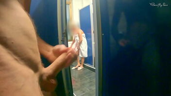 Young beauty in hostel bathroom flashes off her lengthy hair and undergarments.