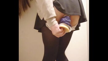 A solo performance of a Chinese girl draining with a dildo in a public setting.