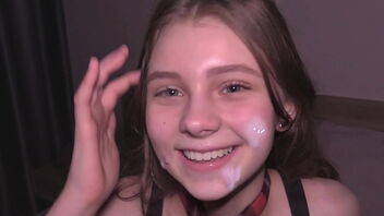 A petite college girl with a slim build gets cum on her face and body.