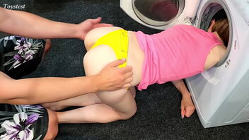 Amateur MILF gets stuck in washing machine and enjoys it while being serviced doggystyle by a diminutive babe with a strapon.