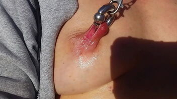 Hot milf jacks outdoors with vibrator and has pierced nipples.